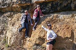 Students examine rock wall during alternative break trip