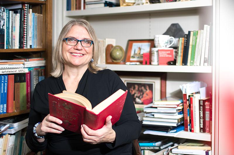 Karen Sorenson poses for photo in her office