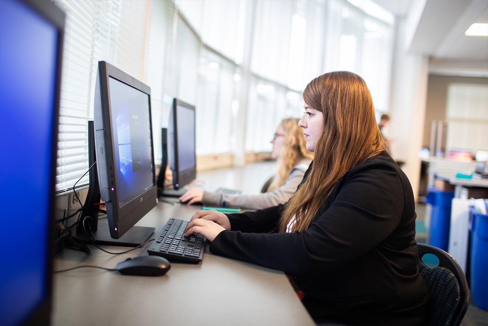 student studying at a laptop