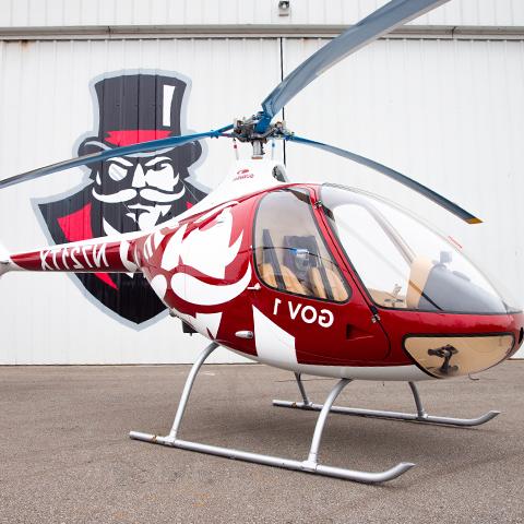 Rotor wing helicopters in front of hanger